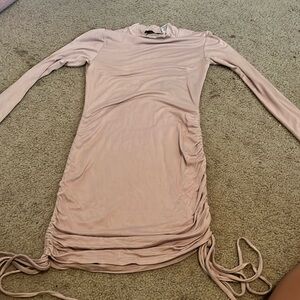 Tan long sleeve mock neck bodycon dress with sinched sides and ties